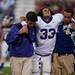 Pioneer junior defensive end Adam Farha is helped off the field after an injury in the first half against Dexter on Friday. Daniel Brenner I AnnArbor.com